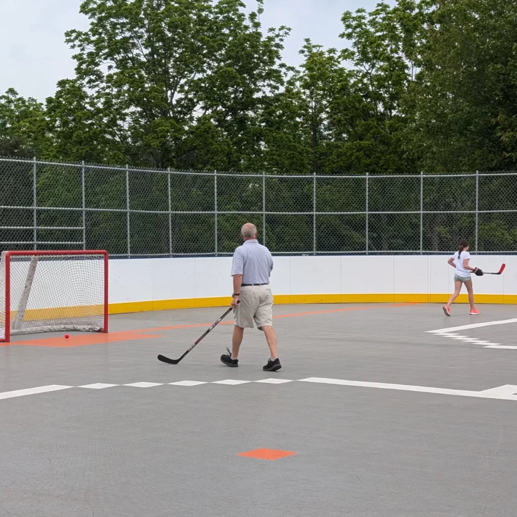 Grandpop and granddaughter playing hockey